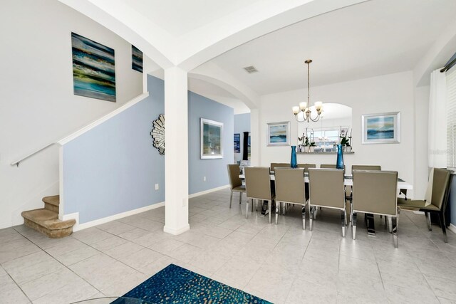 2209 Crofton Ave, Davenport, FL 33837 - dining room with a chandelier, arched walkways, stairway, tile patterned floors, and baseboards