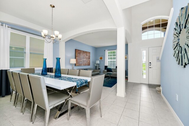2209 Crofton Ave, Davenport, FL 33837 - dining space with a chandelier, arched walkways, light tile patterned floors, and baseboards