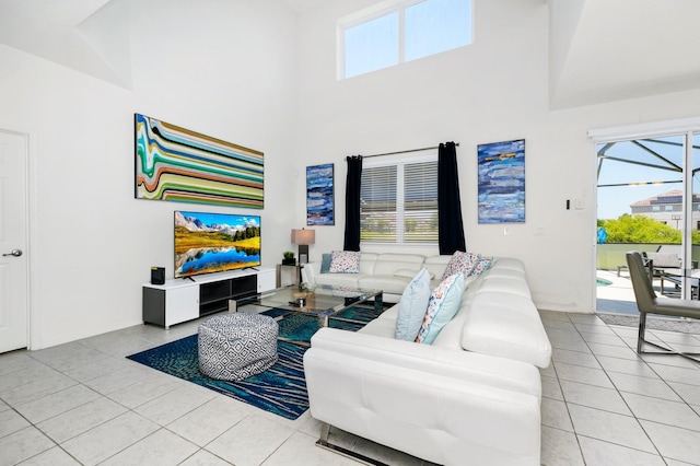 2209 Crofton Ave, Davenport, FL 33837 - living area with a high ceiling, light tile patterned floors, and baseboards