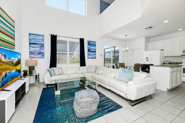 2209 Crofton Ave, Davenport, FL 33837 - living room with a chandelier, light tile patterned floors, a towering ceiling, and recessed lighting