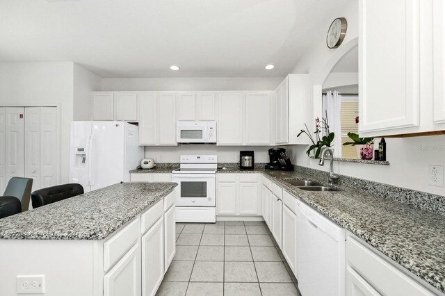 2209 Crofton Ave, Davenport, FL 33837 - kitchen with white appliances, a sink, white cabinets, and recessed lighting
