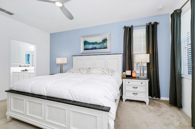 2209 Crofton Ave, Davenport, FL 33837 - bedroom featuring light colored carpet, ensuite bathroom, ceiling fan, and baseboards