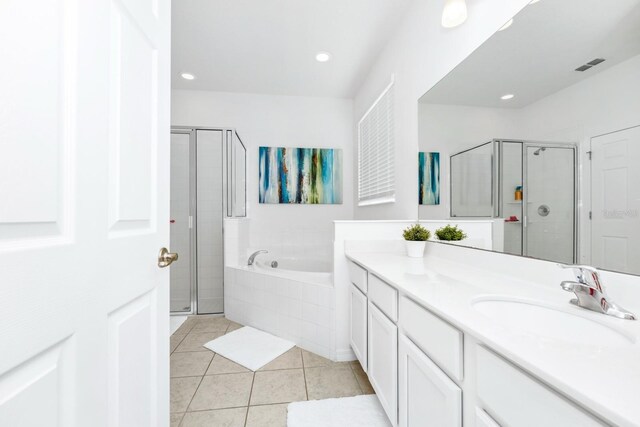 2209 Crofton Ave, Davenport, FL 33837 - full bathroom with vanity, tile patterned floors, a garden tub, a stall shower, and recessed lighting