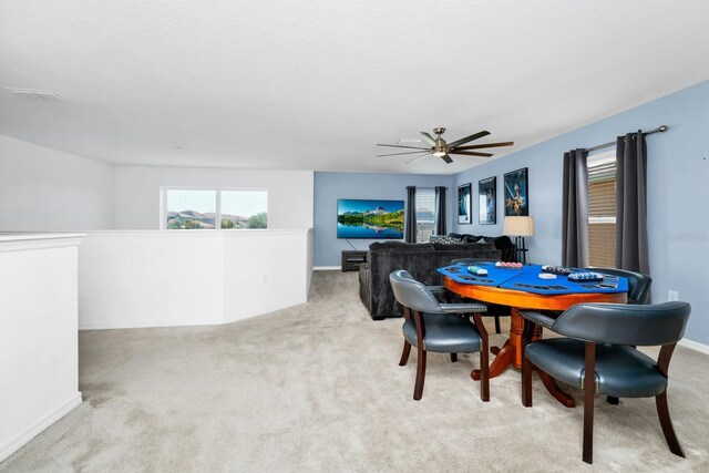 2209 Crofton Ave, Davenport, FL 33837 - dining area with light carpet, a ceiling fan, and baseboards