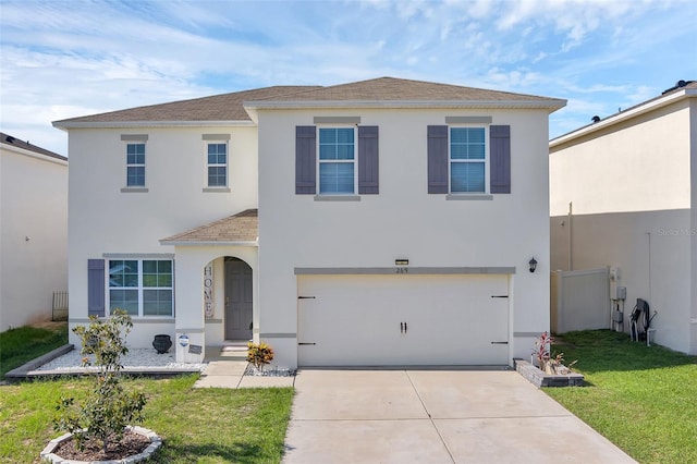 269 Ludisia Loop, Davenport, FL 33837 - view of front of house featuring roof with shingles, stucco siding, an attached garage, concrete driveway, and a front lawn
