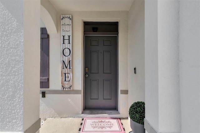 269 Ludisia Loop, Davenport, FL 33837 - doorway to property with stucco siding