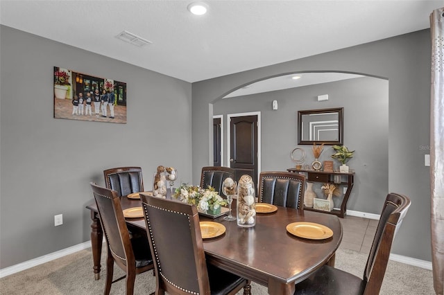269 Ludisia Loop, Davenport, FL 33837 - dining area featuring arched walkways, carpet floors, and baseboards