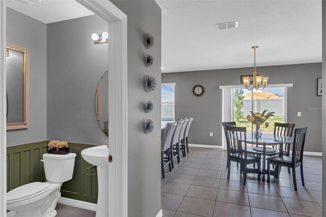 269 Ludisia Loop, Davenport, FL 33837 - dining space with a chandelier, tile patterned flooring, and baseboards