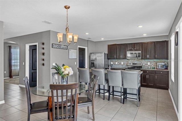 269 Ludisia Loop, Davenport, FL 33837 - dining room featuring a chandelier, baseboards, plenty of natural light, and recessed lighting