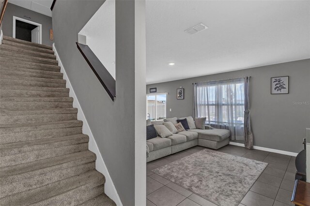 269 Ludisia Loop, Davenport, FL 33837 - living room with stairway, tile patterned flooring, baseboards, and recessed lighting