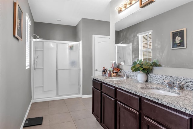 269 Ludisia Loop, Davenport, FL 33837 - full bath featuring baseboards, a shower stall, tile patterned floors, and double vanity
