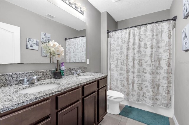 269 Ludisia Loop, Davenport, FL 33837 - full bath with toilet, double vanity, and tile patterned flooring