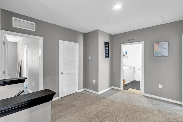 269 Ludisia Loop, Davenport, FL 33837 - unfurnished bedroom featuring baseboards, carpet, attic access, and washer / clothes dryer