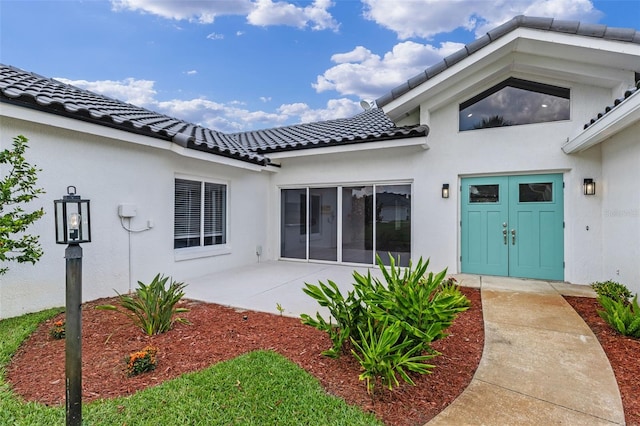 12508 Lake Denise Blvd, Clermont, FL 34711 - doorway to property featuring a tile roof and stucco siding