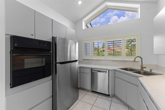12508 Lake Denise Blvd, Clermont, FL 34711 - kitchen featuring appliances with stainless steel finishes, a sink, light countertops, light tile patterned floors, and high vaulted ceiling