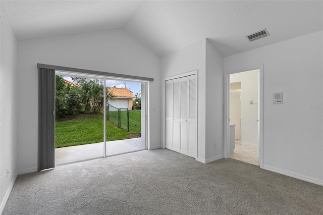 12508 Lake Denise Blvd, Clermont, FL 34711 - unfurnished bedroom featuring access to outside, carpet flooring, vaulted ceiling, a closet, and baseboards