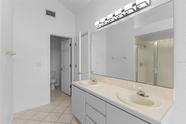 12508 Lake Denise Blvd, Clermont, FL 34711 - bathroom with toilet, a stall shower, double vanity, tile patterned flooring, and baseboards