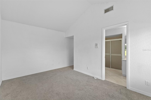 12508 Lake Denise Blvd, Clermont, FL 34711 - unfurnished bedroom with vaulted ceiling, carpet, and baseboards