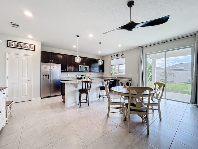 15865 Bradicks Ct, Clermont, FL 34711 - dining area with ceiling fan, recessed lighting, light tile patterned flooring, and a textured ceiling