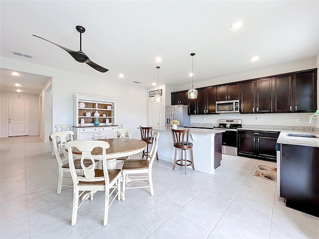 15865 Bradicks Ct, Clermont, FL 34711 - dining room featuring ceiling fan, light tile patterned floors, recessed lighting, and baseboards