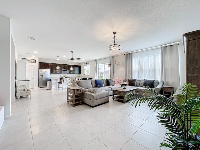 15865 Bradicks Ct, Clermont, FL 34711 - living area featuring light tile patterned floors, recessed lighting, a textured ceiling, baseboards, and ceiling fan