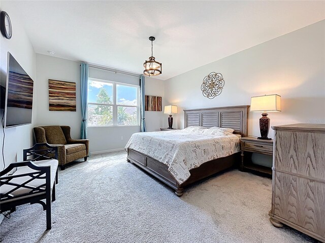 15865 Bradicks Ct, Clermont, FL 34711 - bedroom with light colored carpet, baseboards, and a chandelier
