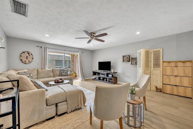 4306 Lake Underhill Rd Unit C, Orlando, FL 32803 - living room featuring ceiling fan, a textured ceiling, light wood-style floors, and recessed lighting