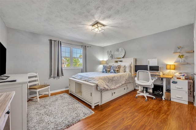 4306 Lake Underhill Rd Unit C, Orlando, FL 32803 - bedroom with wood finished floors, an office area, and a textured ceiling