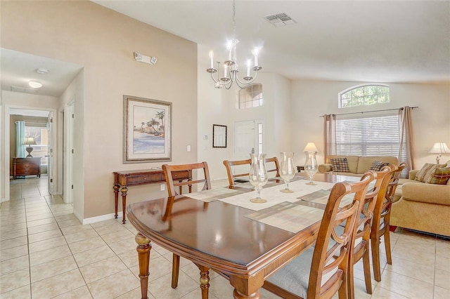 927 Orange Cosmos Blvd, Davenport, FL 33837 - dining area with light tile patterned flooring, a chandelier, and vaulted ceiling
