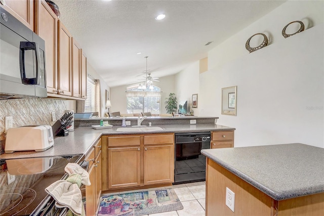 927 Orange Cosmos Blvd, Davenport, FL 33837 - kitchen with dishwasher, vaulted ceiling, a ceiling fan, a peninsula, and light tile patterned floors