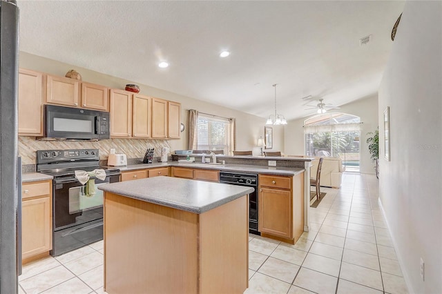 927 Orange Cosmos Blvd, Davenport, FL 33837 - kitchen featuring black appliances, light brown cabinetry, a peninsula, healthy amount of natural light, and lofted ceiling