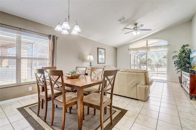 927 Orange Cosmos Blvd, Davenport, FL 33837 - dining area featuring lofted ceiling, light tile patterned floors, a ceiling fan, and a chandelier