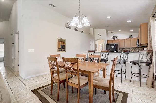 927 Orange Cosmos Blvd, Davenport, FL 33837 - dining room featuring arched walkways, light tile patterned floors, a chandelier, high vaulted ceiling, and recessed lighting