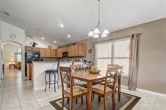 927 Orange Cosmos Blvd, Davenport, FL 33837 - dining room featuring vaulted ceiling, arched walkways, light tile patterned flooring, a chandelier, and recessed lighting