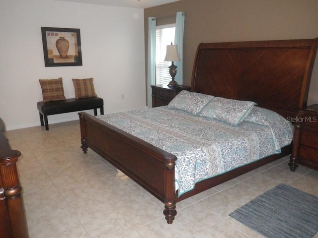 927 Orange Cosmos Blvd, Davenport, FL 33837 - bedroom with light tile patterned floors and baseboards