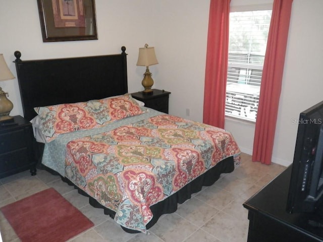 927 Orange Cosmos Blvd, Davenport, FL 33837 - bedroom featuring multiple windows and tile patterned flooring