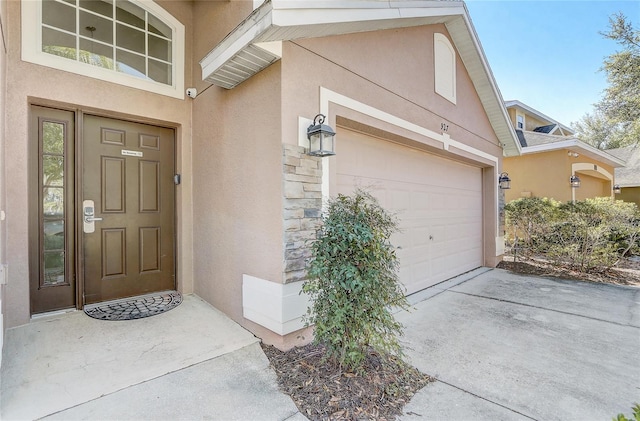 927 Orange Cosmos Blvd, Davenport, FL 33837 - doorway to property featuring stucco siding, concrete driveway, and stone siding