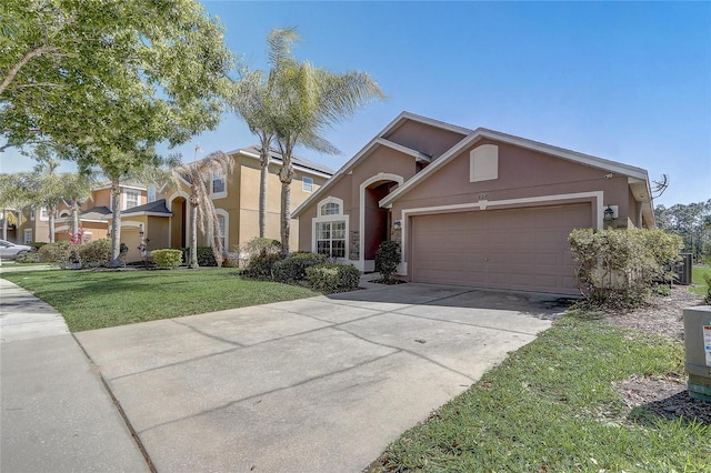 927 Orange Cosmos Blvd, Davenport, FL 33837 - view of front facade featuring an attached garage, concrete driveway, a front yard, and stucco siding