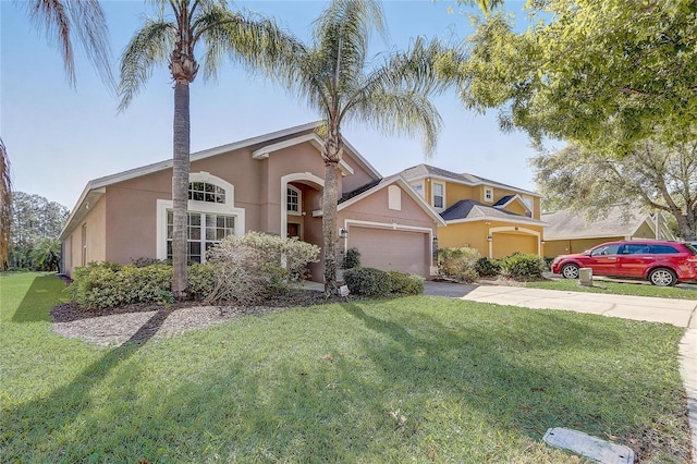 927 Orange Cosmos Blvd, Davenport, FL 33837 - traditional-style home featuring stucco siding, asphalt driveway, a front yard, and an attached garage