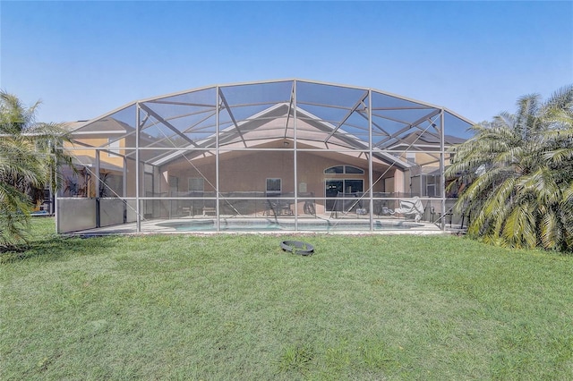 927 Orange Cosmos Blvd, Davenport, FL 33837 - back of property featuring a lawn, an outdoor pool, stucco siding, and a patio area