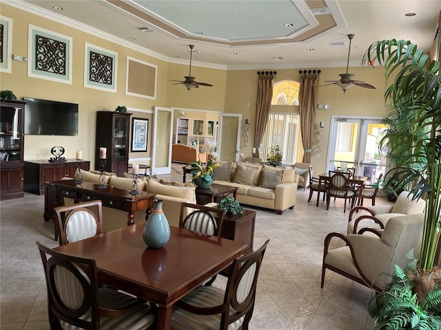 927 Orange Cosmos Blvd, Davenport, FL 33837 - dining area with ceiling fan, a high ceiling, light tile patterned flooring, a raised ceiling, and crown molding