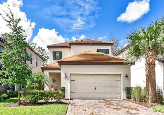 1147 Wildmeadow Run, Winter Park, FL 32792 - mediterranean / spanish-style house featuring decorative driveway, a garage, and stucco siding