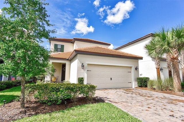 1147 Wildmeadow Run, Winter Park, FL 32792 - mediterranean / spanish-style home with decorative driveway, a garage, stucco siding, and a tile roof