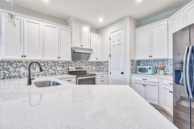 1147 Wildmeadow Run, Winter Park, FL 32792 - kitchen featuring appliances with stainless steel finishes, a sink, under cabinet range hood, white cabinetry, and recessed lighting