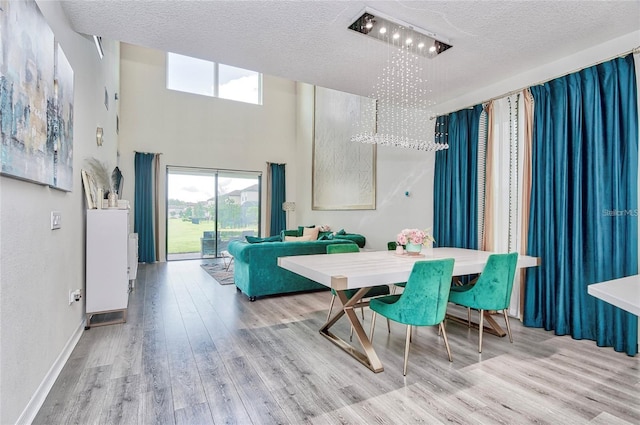 1147 Wildmeadow Run, Winter Park, FL 32792 - dining room with plenty of natural light, wood finished floors, a textured ceiling, and a towering ceiling