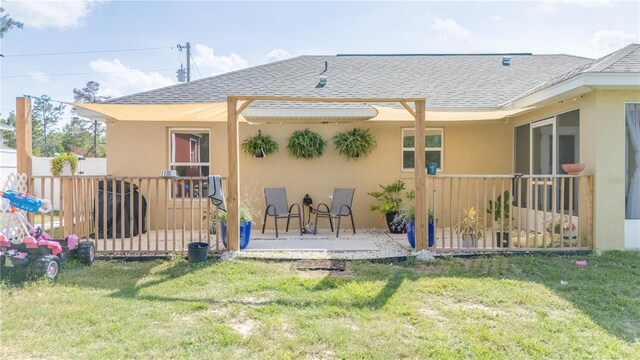 15303 SW 52nd Cir, Ocala, FL 34473 - rear view of house featuring roof with shingles, stucco siding, and a patio