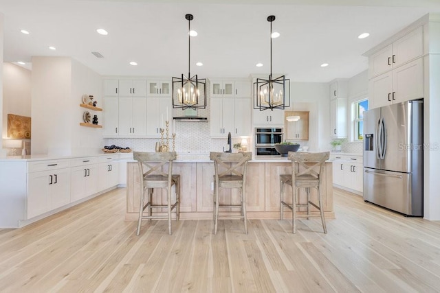 13791 Abberwick Dr, Orlando, FL 32832 - kitchen with stainless steel appliances, a chandelier, light wood-style flooring, backsplash, and recessed lighting