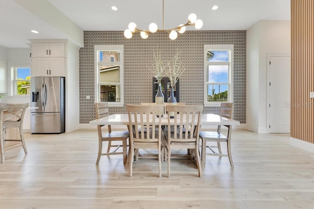 13791 Abberwick Dr, Orlando, FL 32832 - dining room with an accent wall, a chandelier, baseboards, light wood-style floors, and recessed lighting