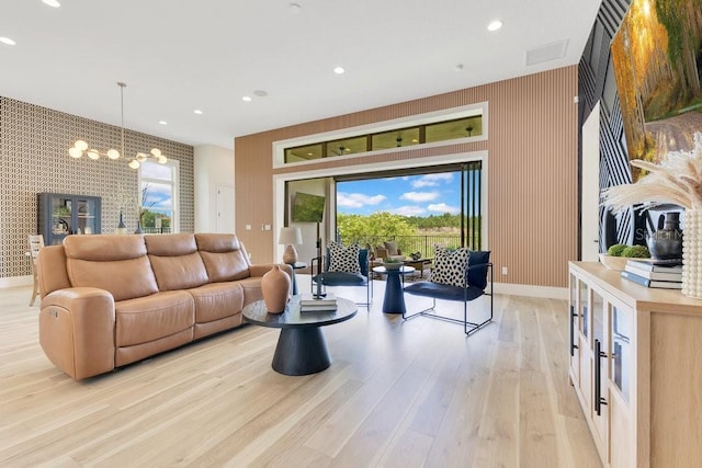 13791 Abberwick Dr, Orlando, FL 32832 - living area with a chandelier, light wood finished floors, baseboards, an accent wall, and recessed lighting