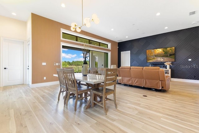 13791 Abberwick Dr, Orlando, FL 32832 - dining space with a chandelier, an accent wall, light wood finished floors, recessed lighting, and baseboards